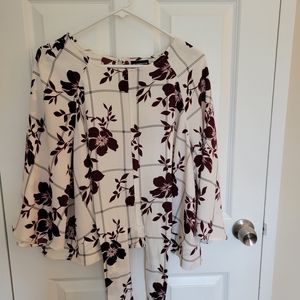 Batwing sleeve blouse with a tie at that waist button in the back.